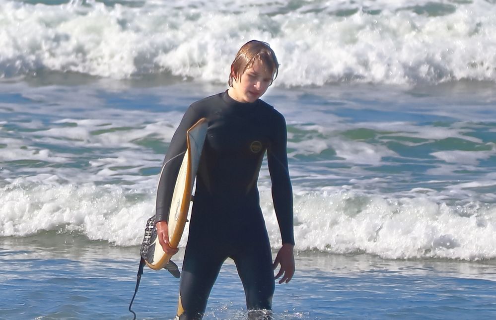 Crop of right surfer