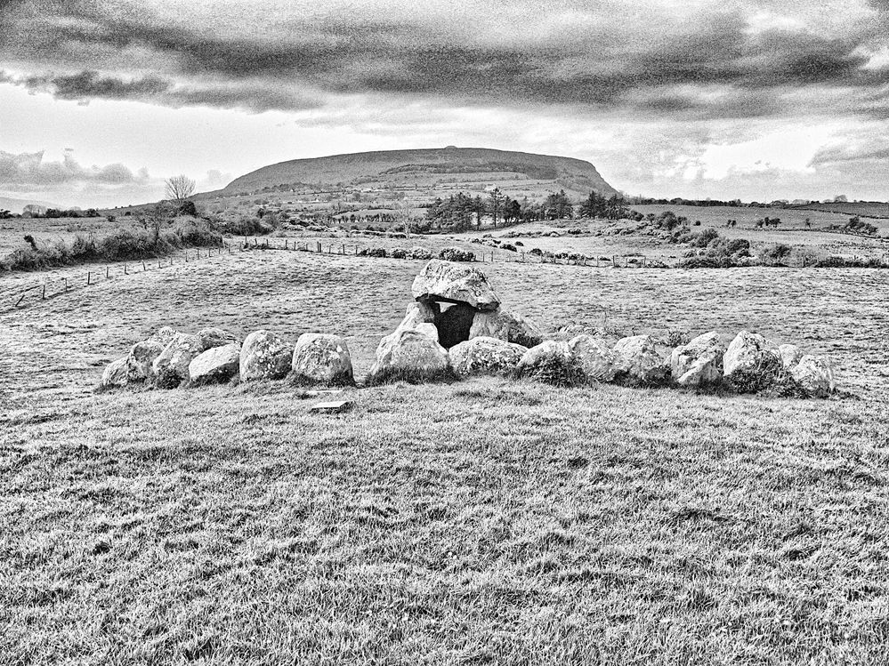 I made this photograph of an alignment  of Megalithic monuments, a stone circle, a passage tomb, and the grave of  Maeve at Knocknarea  seen from Carrowmore,  Sligo,  IE, on April 25, 2007 using old technology. On Jul 26, 2025, I used gimp 3 to convert it to black and white.